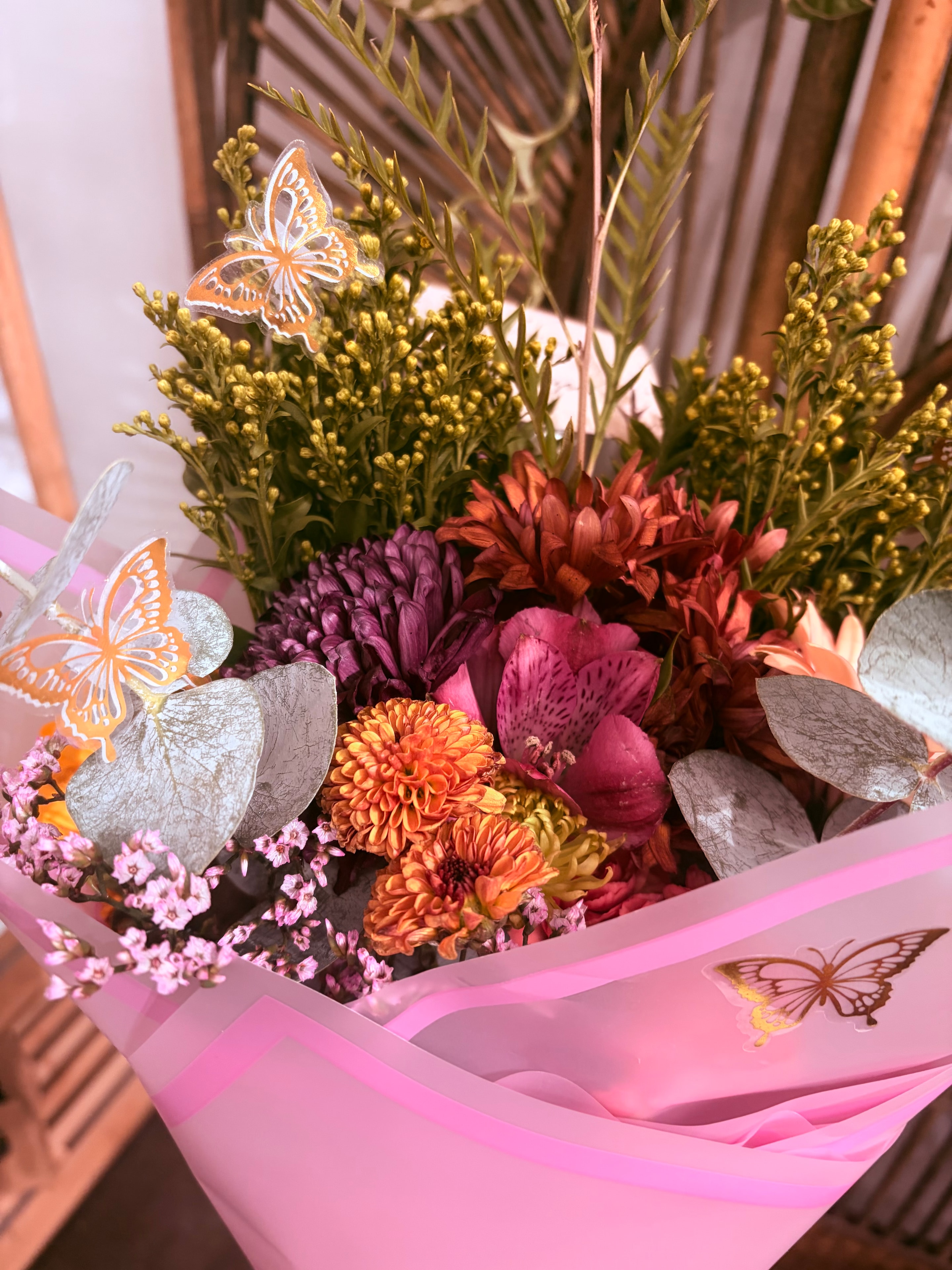 Autumn flower bouquet wrapped in pink paper