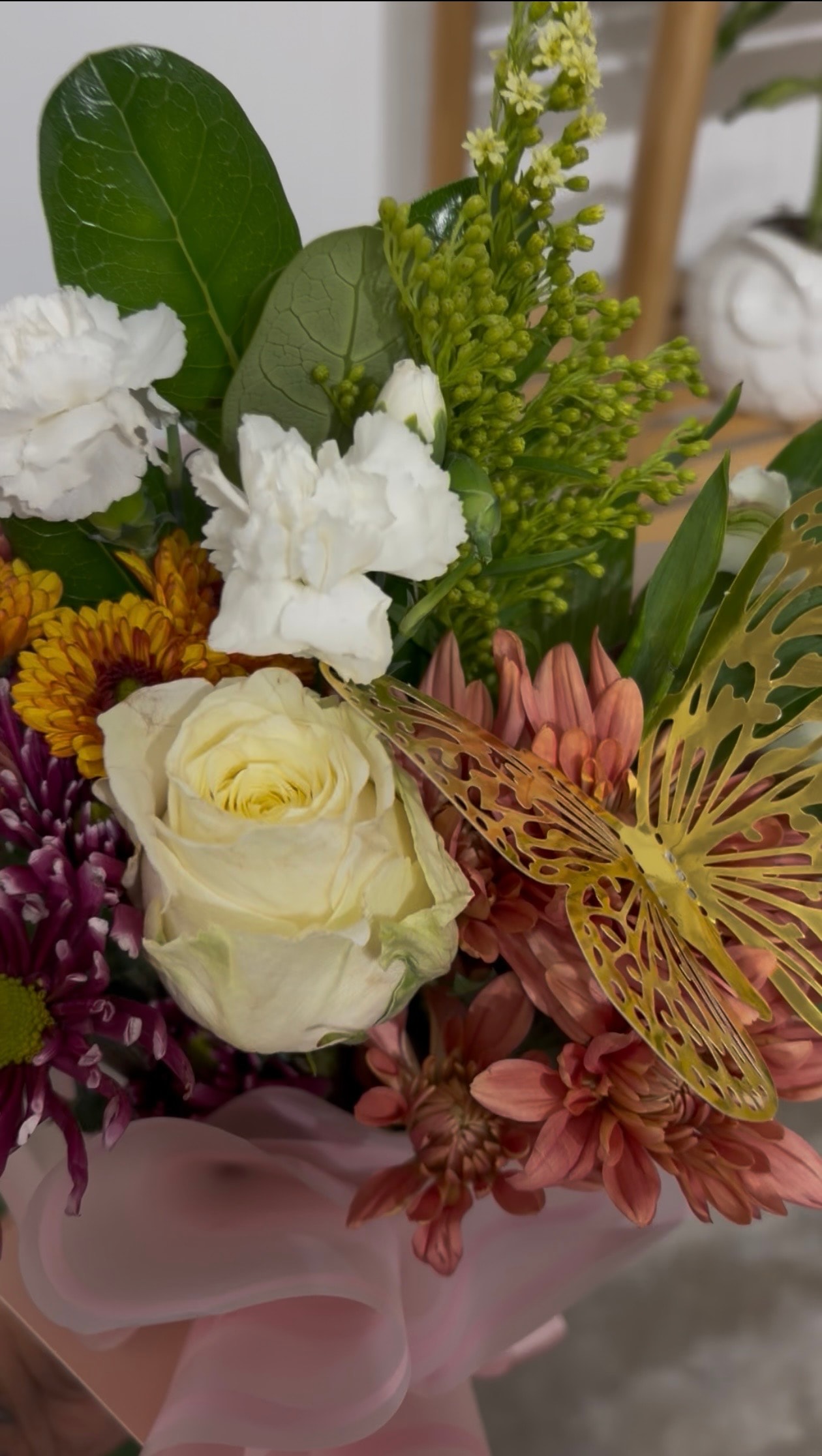 Mixed flower bouquet with gold butterfly