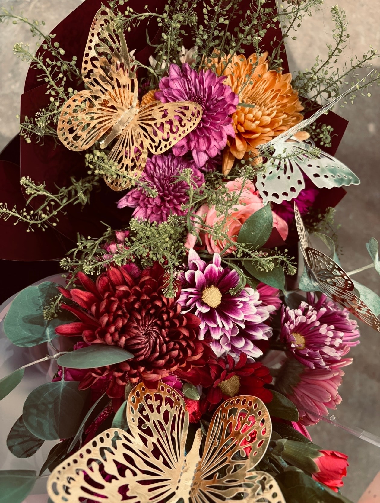 Full bouquet with decorative butterfly on wrapped blooms